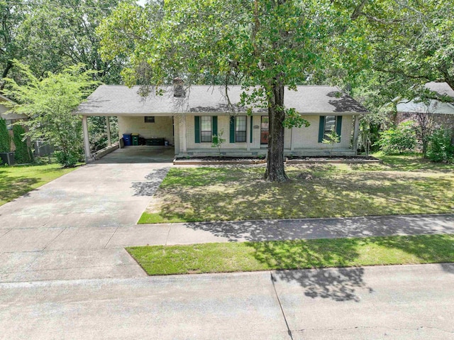 3109 Donaghey Dr, North Little Rock, AR 72116 - view of front of home with driveway, a front lawn, a carport, and brick siding