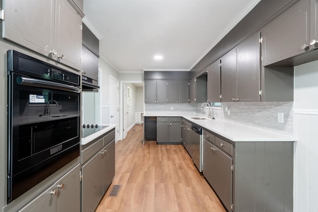 3109 Donaghey Dr, North Little Rock, AR 72116 - kitchen featuring black appliances, gray cabinetry, light wood-type flooring, crown molding, and backsplash
