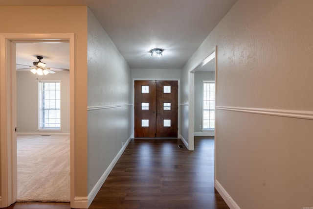 3109 Donaghey Dr, North Little Rock, AR 72116 - entryway featuring dark wood-style flooring, ceiling fan, and a textured wall