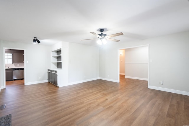 3109 Donaghey Dr, North Little Rock, AR 72116 - unfurnished living room with a ceiling fan and wood finished floors