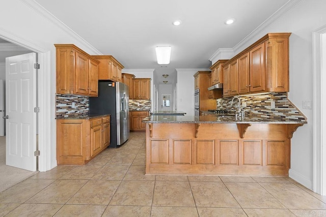 6733 Austin Bay Ct, Sherwood, AR 72120 - kitchen featuring stainless steel appliances, a peninsula, brown cabinets, tasteful backsplash, and recessed lighting