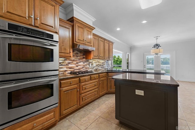 6733 Austin Bay Ct, Sherwood, AR 72120 - kitchen featuring stainless steel double oven, crown molding, backsplash, light tile patterned flooring, and brown cabinets
