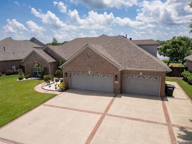 6733 Austin Bay Ct, Sherwood, AR 72120 - view of front of home with driveway, brick siding, roof with shingles, and a garage