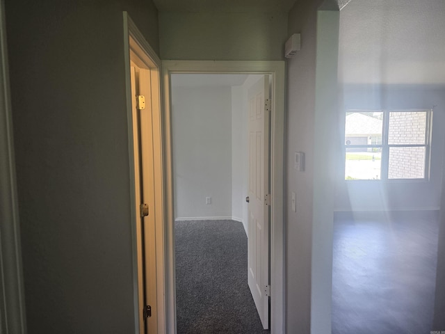 hall featuring baseboards