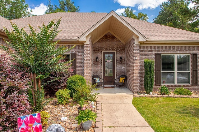 274 Reuben Dr, Alexander, AR 72202 - property entrance featuring roof with shingles, brick siding, and a yard