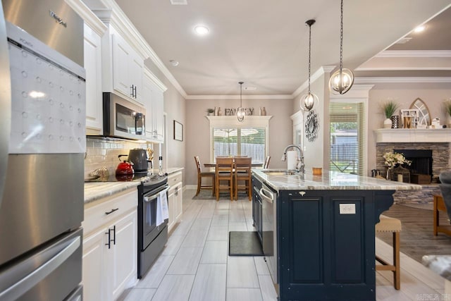 274 Reuben Dr, Alexander, AR 72202 - kitchen featuring appliances with stainless steel finishes, tasteful backsplash, white cabinets, light stone countertops, and open floor plan
