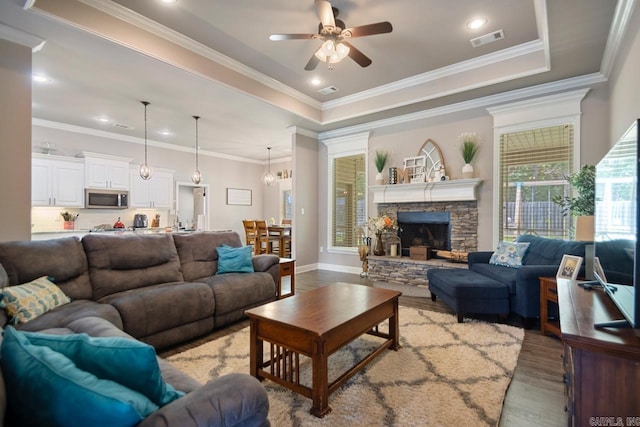 274 Reuben Dr, Alexander, AR 72202 - living room featuring light wood-type flooring, a ceiling fan, a tray ceiling, a fireplace, and crown molding