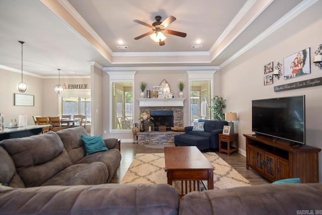 274 Reuben Dr, Alexander, AR 72202 - living room with a raised ceiling, healthy amount of natural light, a ceiling fan, wood finished floors, and crown molding