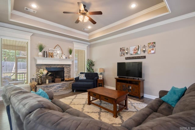 274 Reuben Dr, Alexander, AR 72202 - living area with a tray ceiling, a ceiling fan, wood finished floors, a fireplace, and crown molding