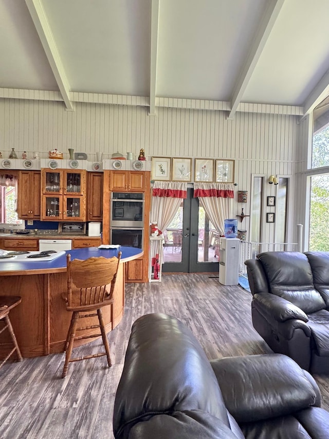 living area featuring beamed ceiling, french doors, and wood finished floors