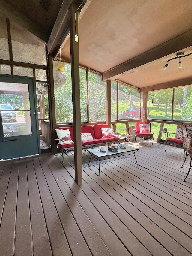 sunroom / solarium with outdoor lounge area and beam ceiling