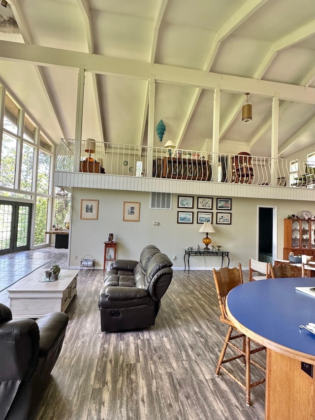 living room with high vaulted ceiling, wood finished floors, beam ceiling, and french doors