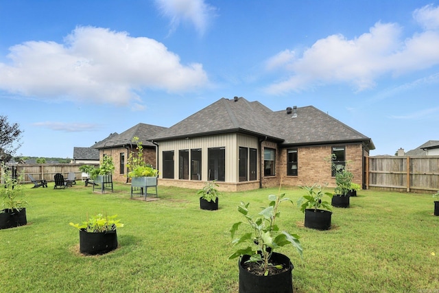 6756 Hilo St, Benton, AR 72019 - back of property with a fenced backyard, brick siding, a sunroom, and a shingled roof