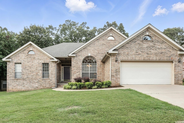 7328 W Ridge Cir, Sherwood, AR 72120 - view of front of house featuring driveway, a front lawn, an attached garage, brick siding, and a shingled roof