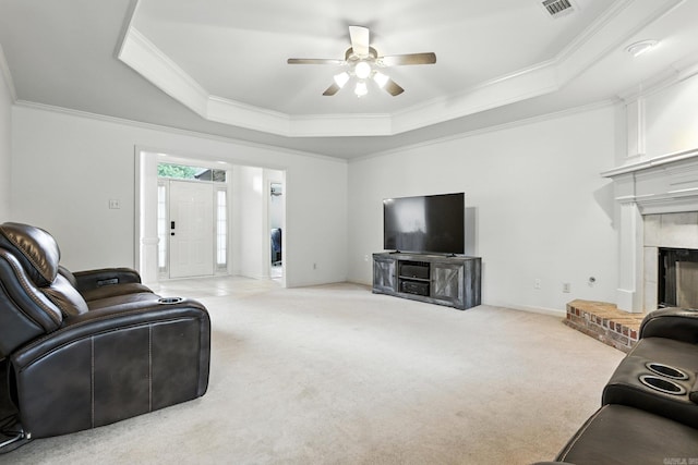 7328 W Ridge Cir, Sherwood, AR 72120 - living area with a tray ceiling, crown molding, carpet flooring, ceiling fan, and a fireplace