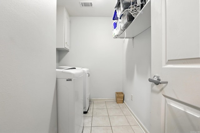 7328 W Ridge Cir, Sherwood, AR 72120 - laundry area with washer and dryer, light tile patterned floors, and cabinet space