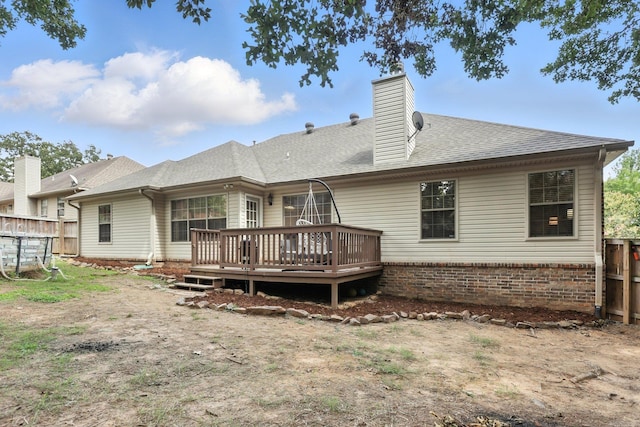 7328 W Ridge Cir, Sherwood, AR 72120 - back of house with a deck, a chimney, a shingled roof, and brick siding
