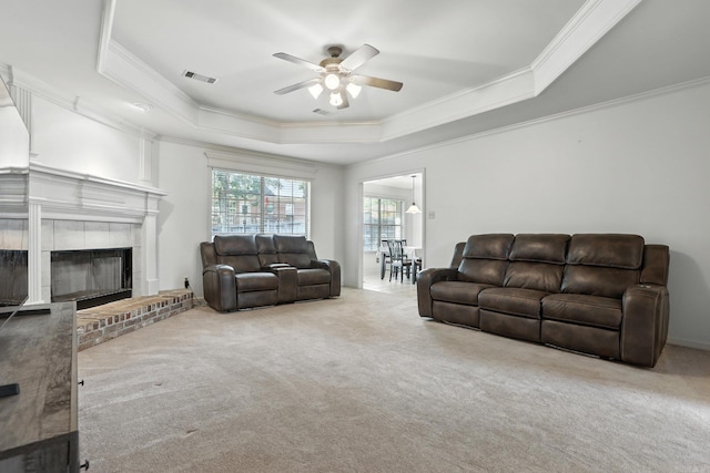 7328 W Ridge Cir, Sherwood, AR 72120 - living area featuring a tray ceiling, crown molding, a ceiling fan, carpet flooring, and a brick fireplace