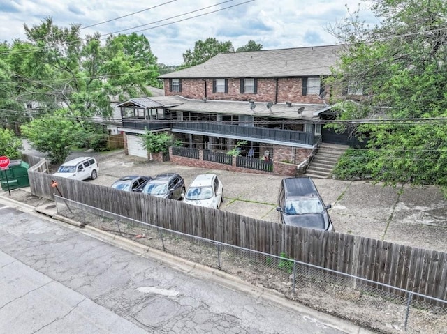 rear view of property featuring stairway and brick siding