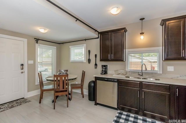 kitchen with stainless steel dishwasher, dark brown cabinetry, light countertops, and pendant lighting