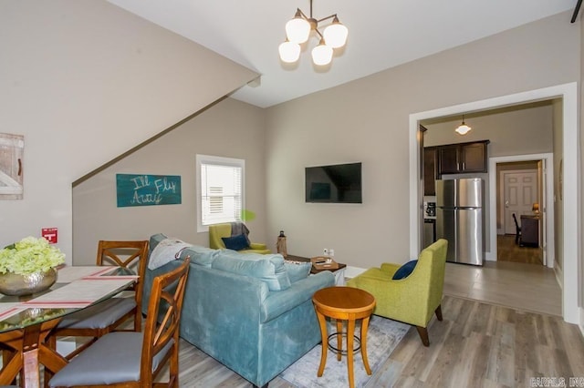 living area with a chandelier and light wood-style floors