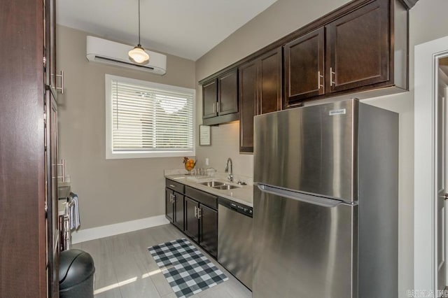 kitchen with appliances with stainless steel finishes, an AC wall unit, dark brown cabinets, light countertops, and pendant lighting