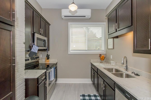 kitchen featuring a wall mounted AC, stainless steel appliances, dark brown cabinetry, and light stone countertops