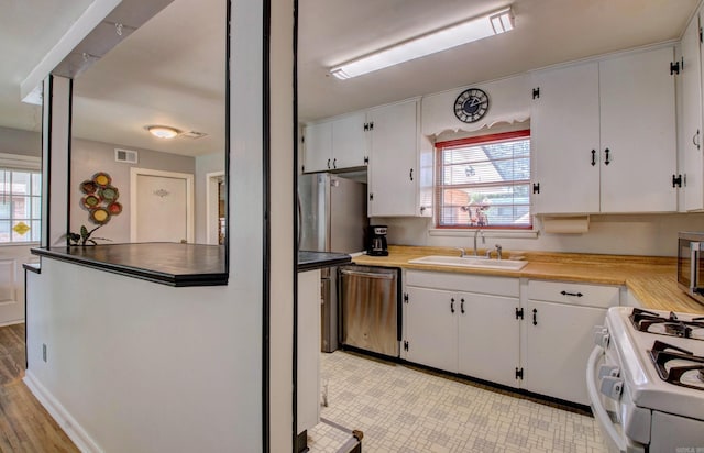 111 Greenland Cv, Little Rock, AR 72204 - kitchen featuring white gas stove, dishwasher, and white cabinets