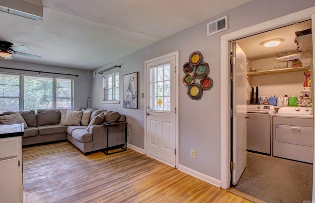 111 Greenland Cv, Little Rock, AR 72204 - living area featuring washer and clothes dryer, light wood-style floors, and ceiling fan