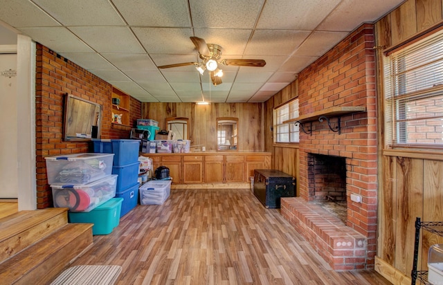 111 Greenland Cv, Little Rock, AR 72204 - kitchen with open shelves, wooden walls, light wood-type flooring, a paneled ceiling, and a ceiling fan