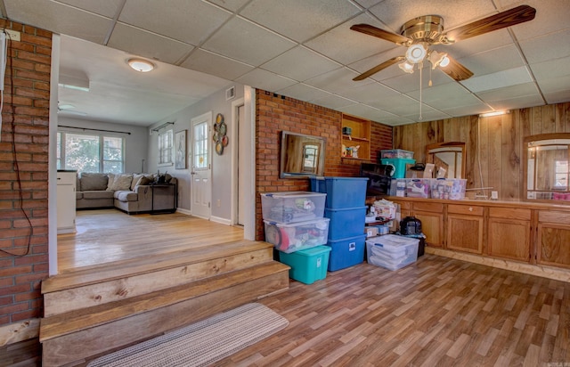 111 Greenland Cv, Little Rock, AR 72204 - interior space with light wood finished floors, a ceiling fan, wood walls, and a paneled ceiling