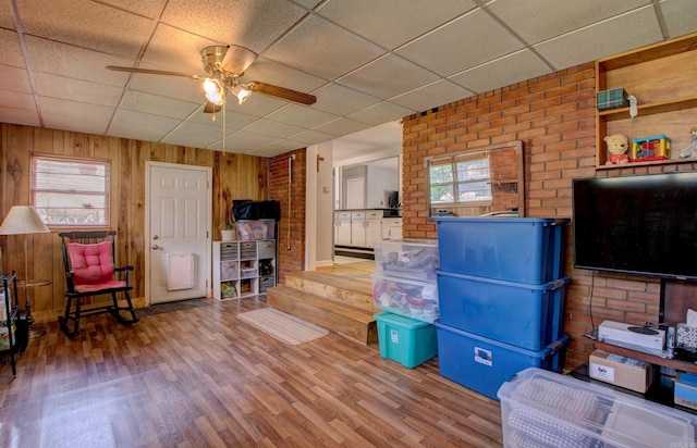 111 Greenland Cv, Little Rock, AR 72204 - living room with a ceiling fan, a drop ceiling, wood finished floors, healthy amount of natural light, and wood walls