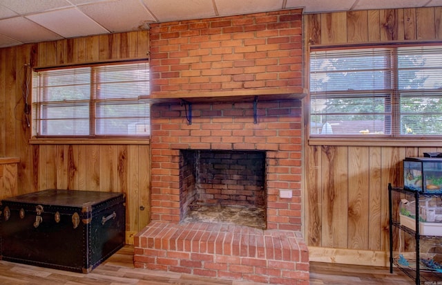 111 Greenland Cv, Little Rock, AR 72204 - unfurnished living room featuring wooden walls, wood finished floors, and a paneled ceiling