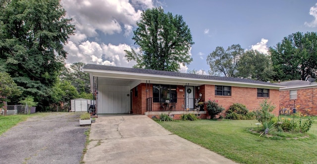 111 Greenland Cv, Little Rock, AR 72204 - ranch-style home featuring concrete driveway, a shed, a front yard, an attached carport, and a porch
