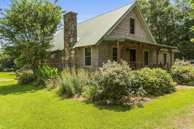 1105 Long Branch Rd, Heber Springs, AR 72543 - view of side of property featuring a lawn, a metal roof, and a chimney