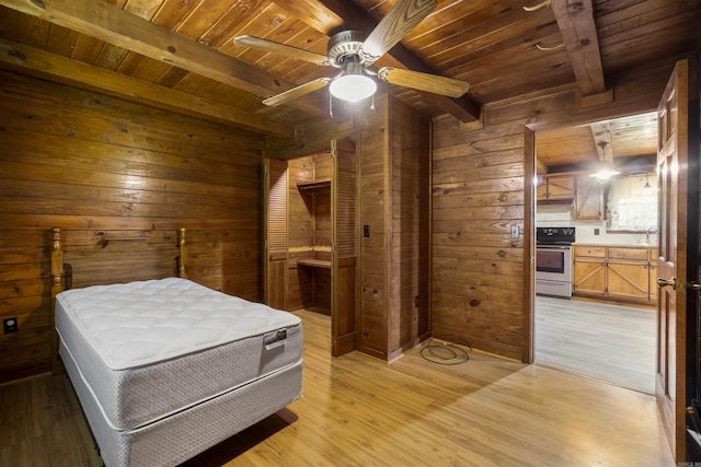 1105 Long Branch Rd, Heber Springs, AR 72543 - bedroom with a wood ceiling with exposed beams, wood walls, light wood-type flooring, ensuite bathroom, and a ceiling fan