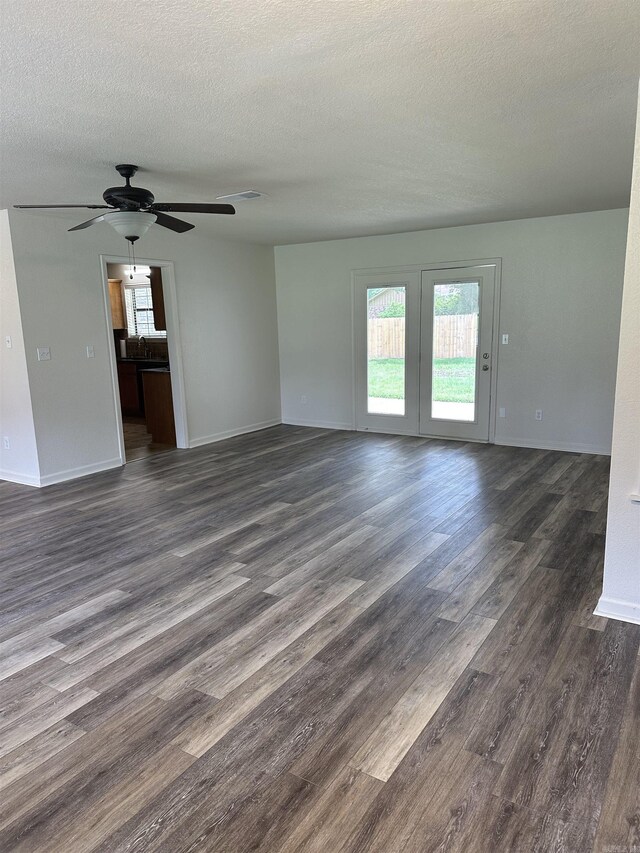 3505 Stockton Dr, Benton, AR 72015 - unfurnished living room featuring plenty of natural light, dark wood-style flooring, a textured ceiling, and a ceiling fan