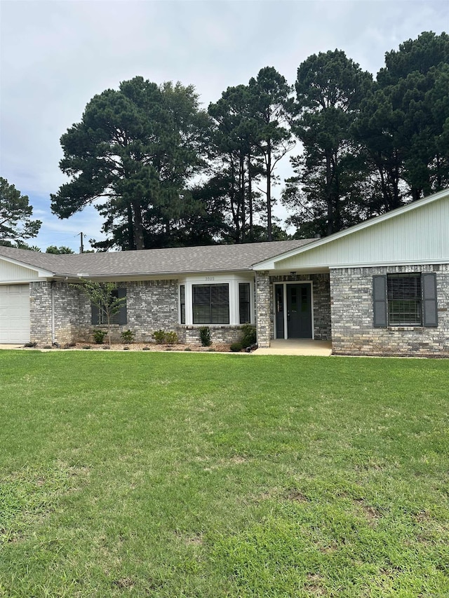 3505 Stockton Dr, Benton, AR 72015 - view of front of home featuring a front lawn, brick siding, and a garage