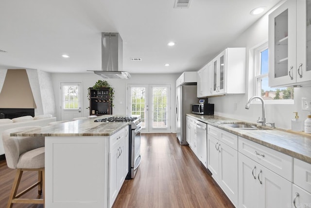 26 Buttermilk Rd, Little Rock, AR 72227 - kitchen with stainless steel appliances, island exhaust hood, healthy amount of natural light, light stone counters, and recessed lighting