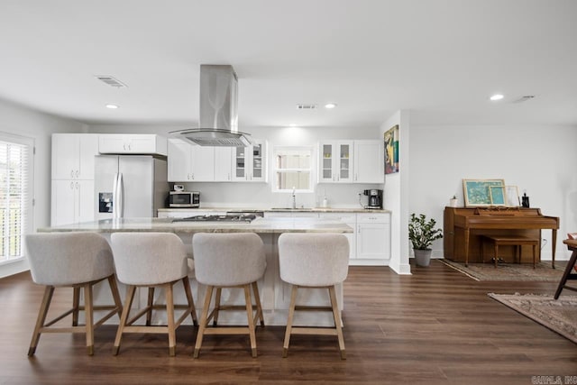 26 Buttermilk Rd, Little Rock, AR 72227 - kitchen with appliances with stainless steel finishes, island exhaust hood, a center island, glass insert cabinets, and white cabinetry