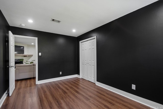 26 Buttermilk Rd, Little Rock, AR 72227 - spare room with wood finished floors, a large fireplace, and recessed lighting