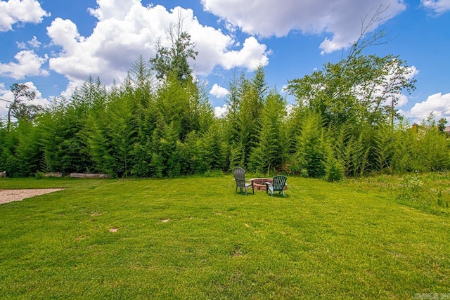 26 Buttermilk Rd, Little Rock, AR 72227 - view of green lawn featuring an outdoor fire pit