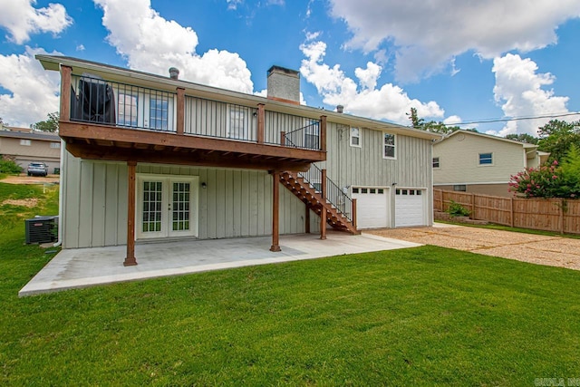 26 Buttermilk Rd, Little Rock, AR 72227 - rear view of property with a chimney, french doors, driveway, an attached garage, and stairs