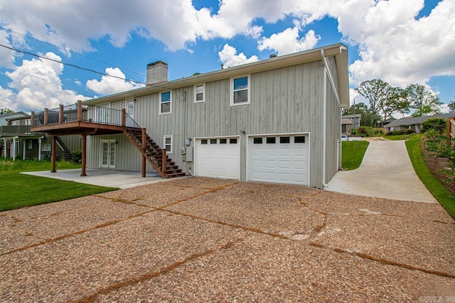 26 Buttermilk Rd, Little Rock, AR 72227 - rear view of property featuring stairway, driveway, a wooden deck, and a chimney