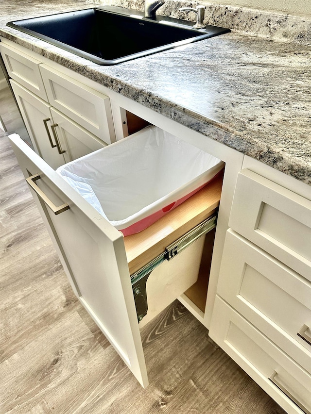 377 N 3rd St Unit B, Black Rock, AR 72415 - kitchen view of light wood-style floors and white cabinets