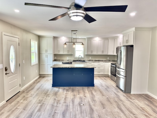 377 N 3rd St Unit B, Black Rock, AR 72415 - kitchen with stainless steel appliances, a ceiling fan, a kitchen island, light wood finished floors, and recessed lighting