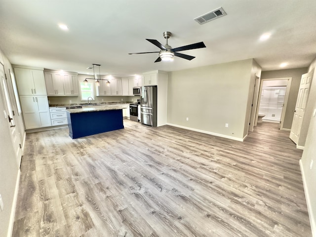 377 N 3rd St Unit B, Black Rock, AR 72415 - kitchen with appliances with stainless steel finishes, ceiling fan, light wood-style floors, open floor plan, and recessed lighting