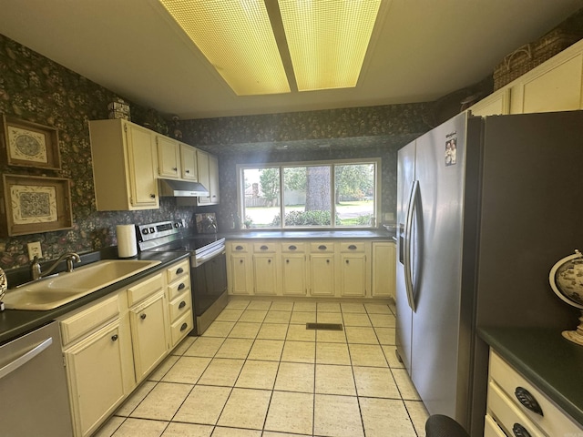 4 Jullian Cir, Dumas, AR 71639 - kitchen with stainless steel appliances, wallpapered walls, light tile patterned floors, under cabinet range hood, and dark countertops