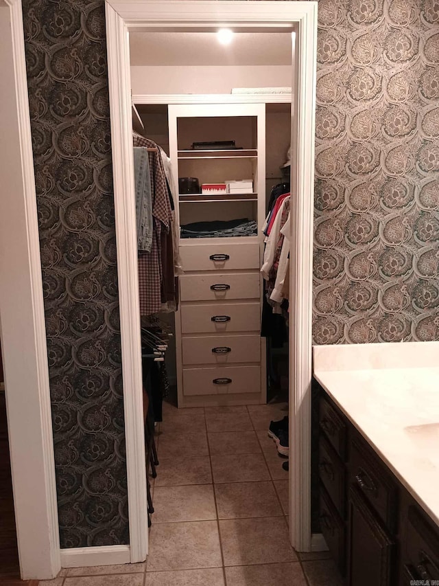 4 Jullian Cir, Dumas, AR 71639 - bathroom with vanity, a walk in closet, and tile patterned floors
