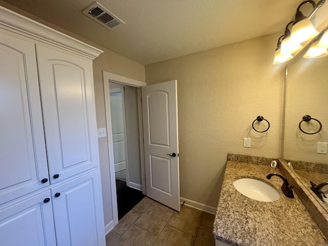 24 Tradewinds Dr, Cabot, AR 72023 - bathroom with vanity, tile patterned floors, a textured wall, and a textured ceiling